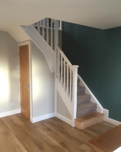 Hallway and staircase decorated in deep green and white