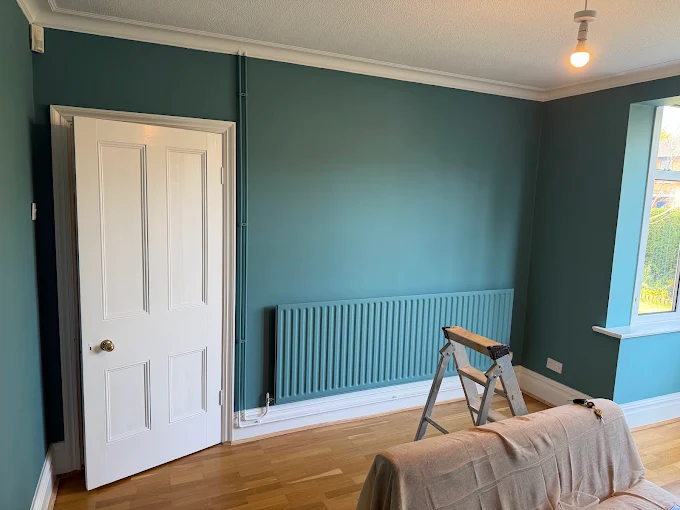 Bedroom walls, ceiling and radiator finished in teal