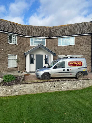 J Beedham Decorating Services van outside a Lincolnshire home with a newly painted porch